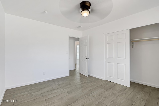 unfurnished bedroom with light hardwood / wood-style floors, a closet, and ceiling fan