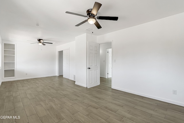 unfurnished room with wood-type flooring and ceiling fan