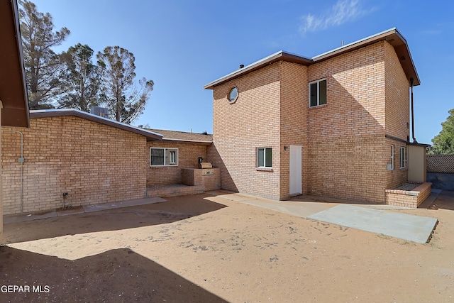 rear view of property featuring a patio area