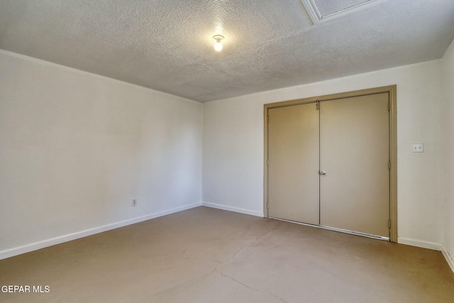 unfurnished bedroom with a textured ceiling and a closet