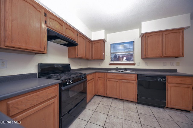 kitchen with sink, light tile patterned floors, a textured ceiling, and black appliances