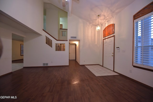 foyer featuring hardwood / wood-style flooring and a high ceiling