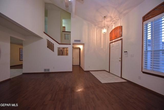 entryway featuring hardwood / wood-style flooring and high vaulted ceiling