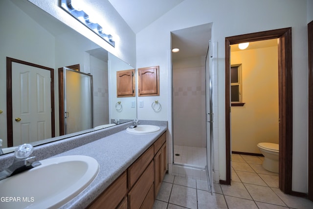 bathroom featuring toilet, a shower with shower door, vaulted ceiling, vanity, and tile patterned flooring