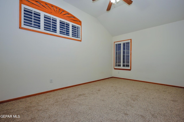 spare room with ceiling fan, lofted ceiling, and carpet flooring