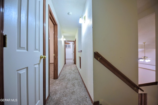 hallway featuring light colored carpet