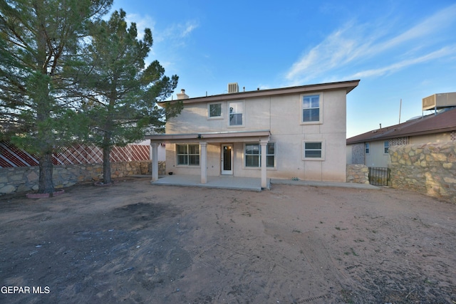 back of house with a patio