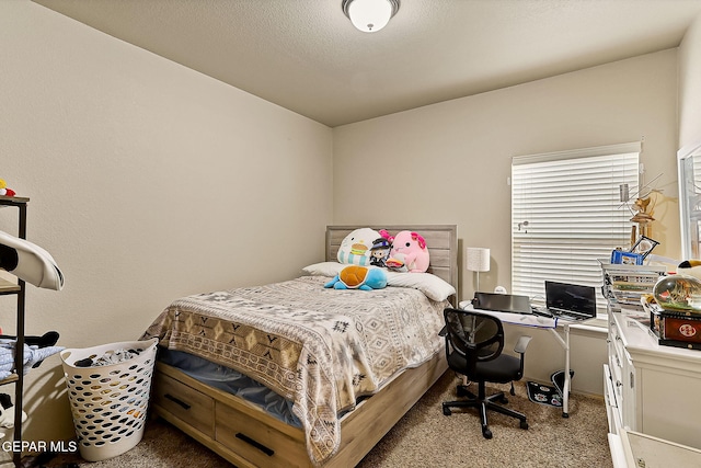 bedroom featuring light carpet and a textured ceiling