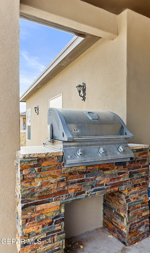 view of patio with an outdoor kitchen and a grill