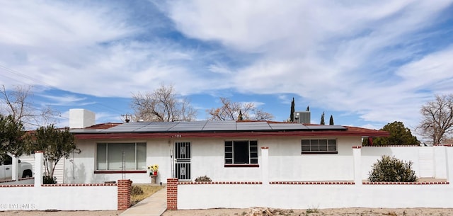 single story home with central air condition unit and solar panels