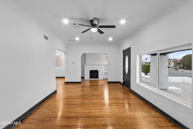 unfurnished living room featuring hardwood / wood-style floors and ceiling fan