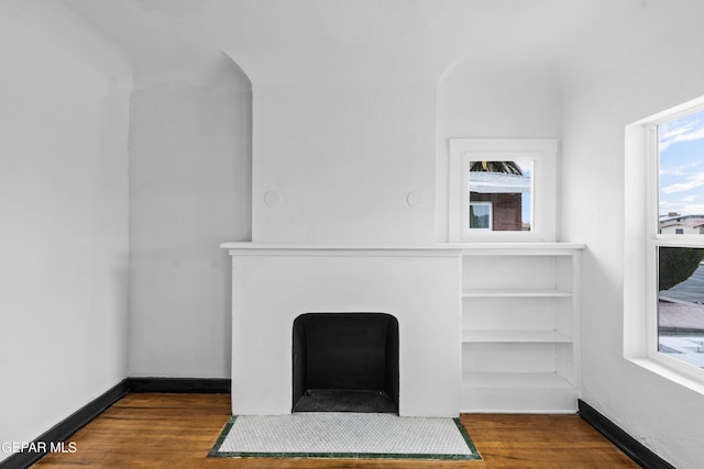 unfurnished living room featuring dark hardwood / wood-style floors