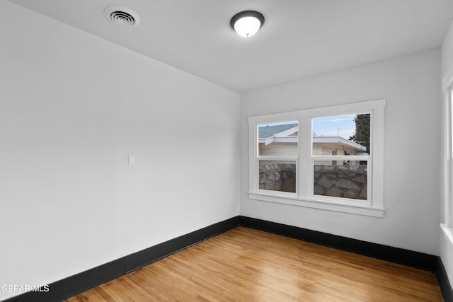 unfurnished room featuring hardwood / wood-style flooring