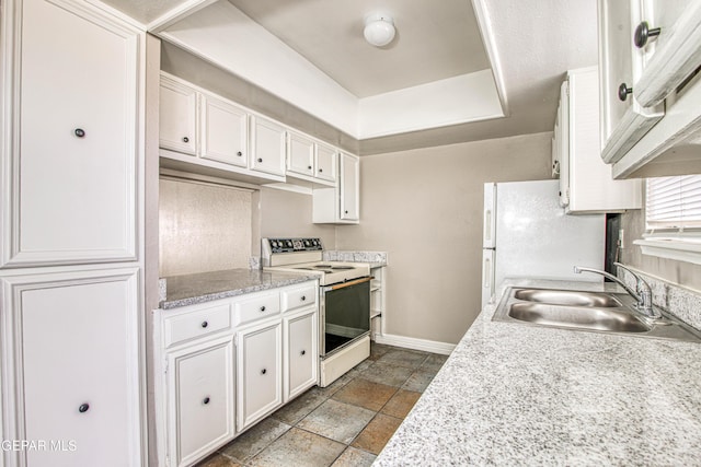 kitchen featuring white cabinetry, white appliances, a raised ceiling, and sink