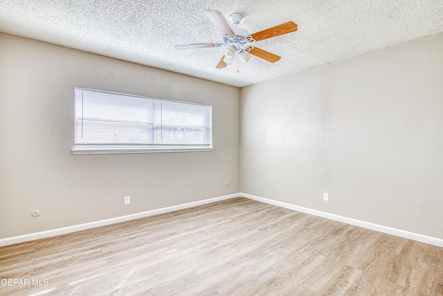 spare room featuring ceiling fan, a textured ceiling, and light wood-type flooring