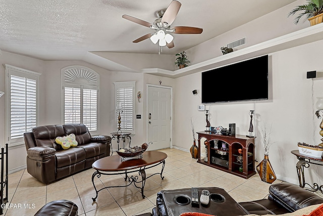 tiled living room featuring a textured ceiling and ceiling fan