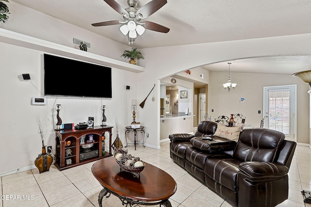 living room featuring lofted ceiling, ceiling fan with notable chandelier, and light tile patterned floors