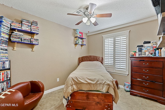 bedroom featuring ceiling fan, a textured ceiling, and light tile patterned flooring