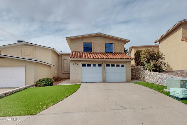 view of front of property with a garage and a front lawn