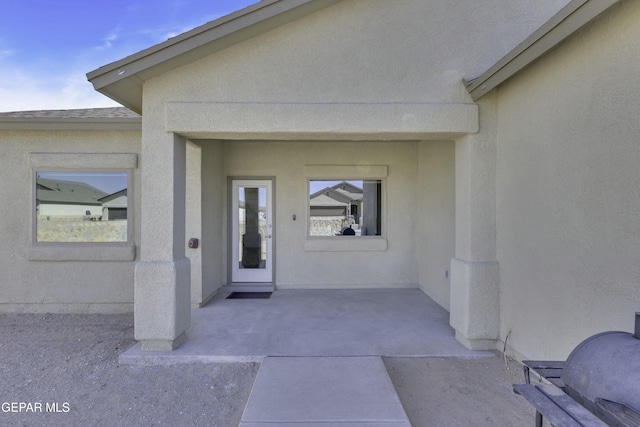 property entrance with a patio area