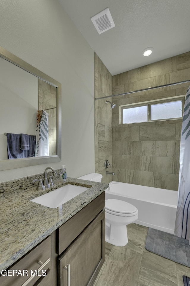 full bathroom featuring toilet, vanity, and shower / tub combo