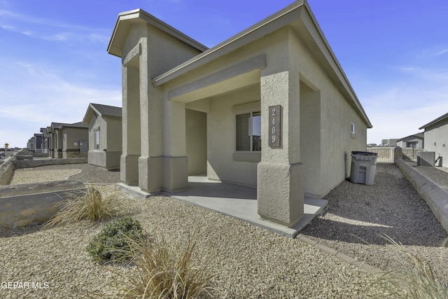 view of property exterior featuring a patio and central AC