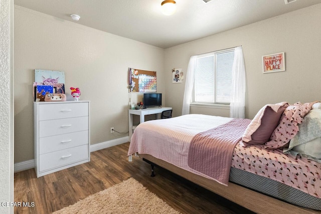 bedroom featuring dark wood-type flooring and baseboards