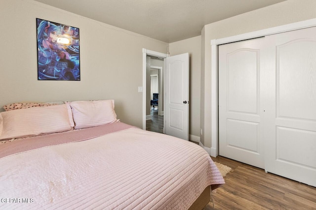 bedroom with a closet and wood finished floors