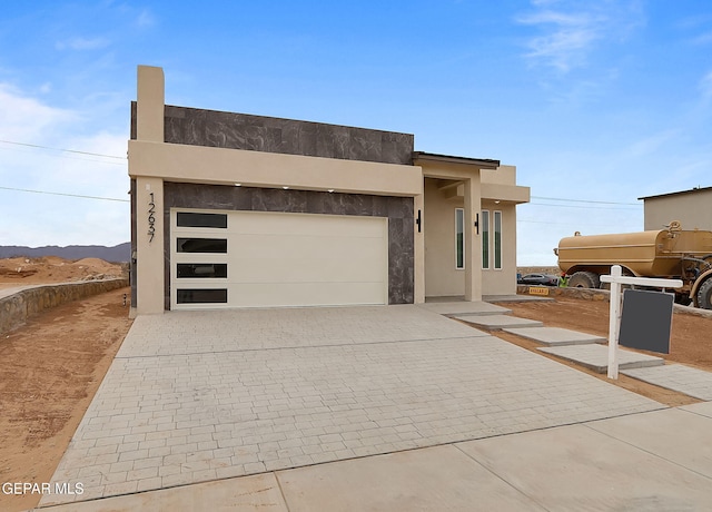 view of front of home featuring a mountain view and a garage