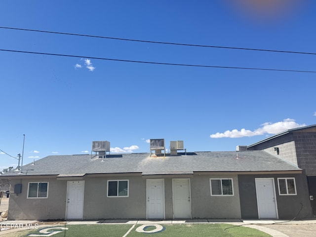 single story home with central AC unit and a front lawn