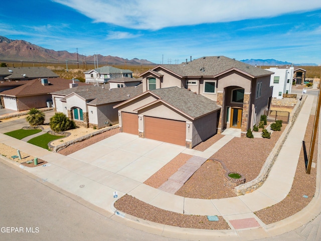 view of front of house featuring a garage and a mountain view