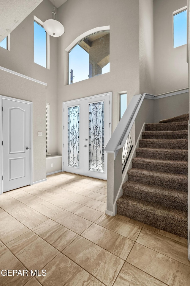 foyer featuring a high ceiling and french doors