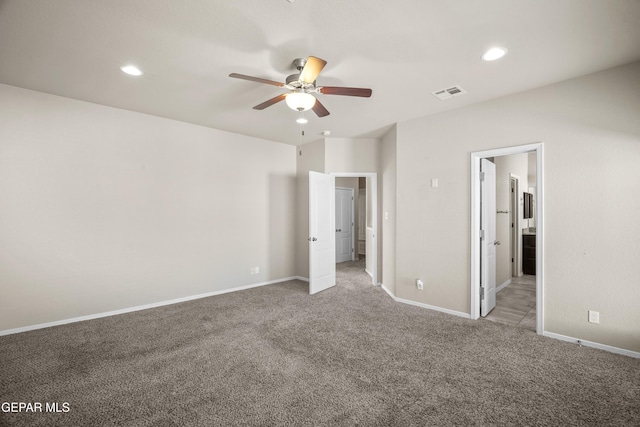 unfurnished bedroom featuring carpet floors, ensuite bathroom, and ceiling fan