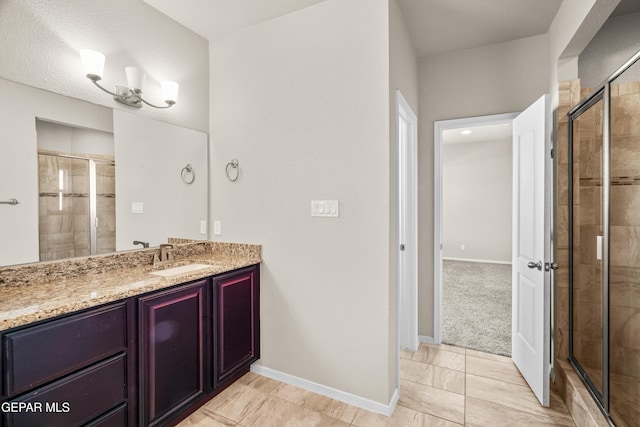 bathroom featuring an enclosed shower and vanity