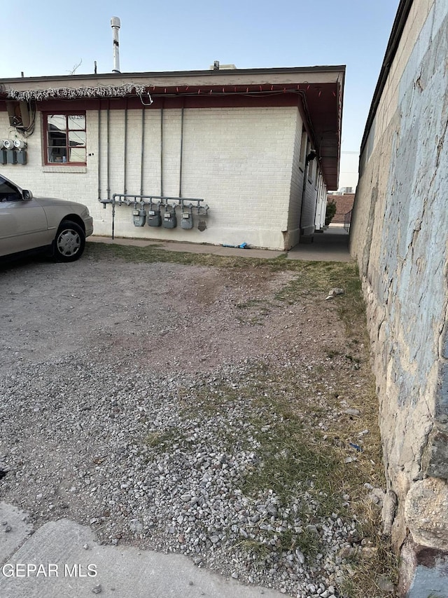 view of side of property featuring brick siding