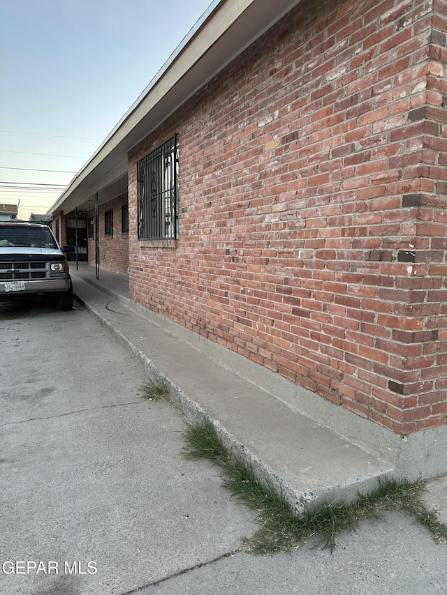 view of side of property with brick siding