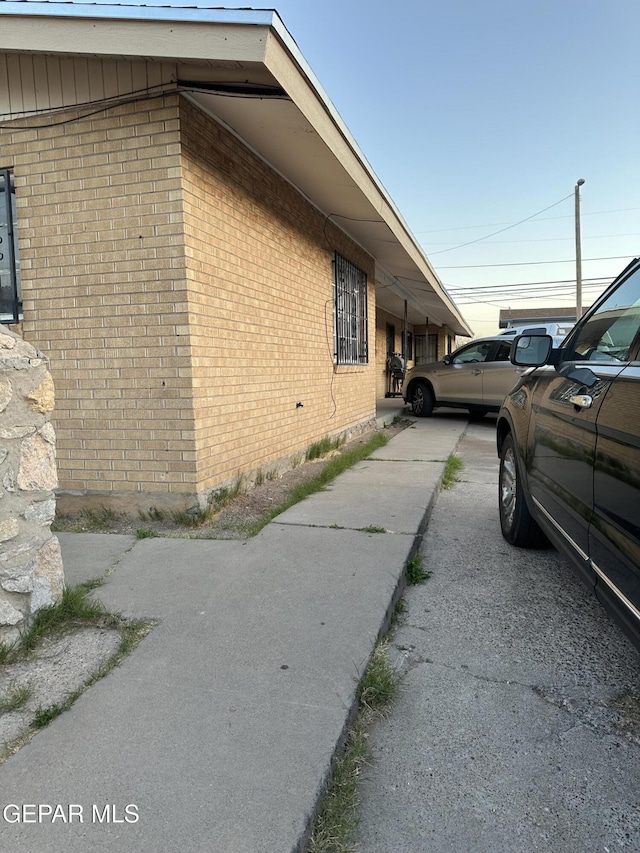 view of side of property with brick siding