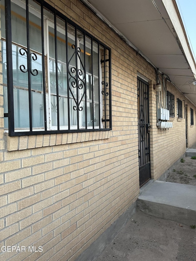 view of property exterior with brick siding