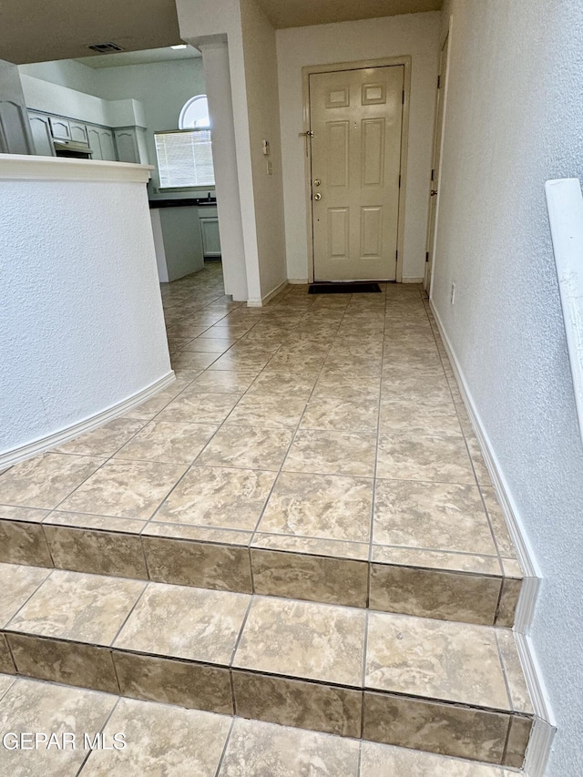 hallway with light tile patterned floors