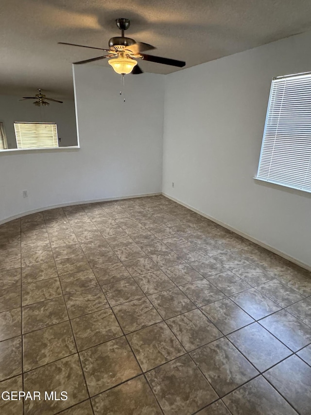 spare room featuring a textured ceiling and ceiling fan