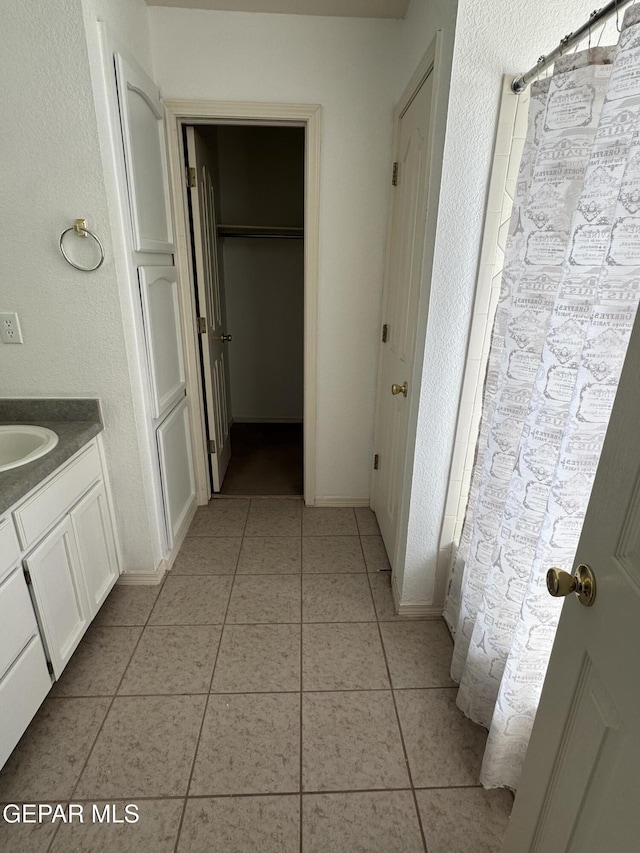 bathroom with tile patterned flooring and vanity