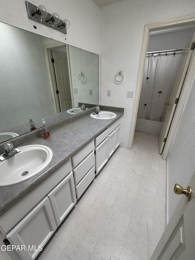 bathroom featuring vanity and shower / bath combination with curtain