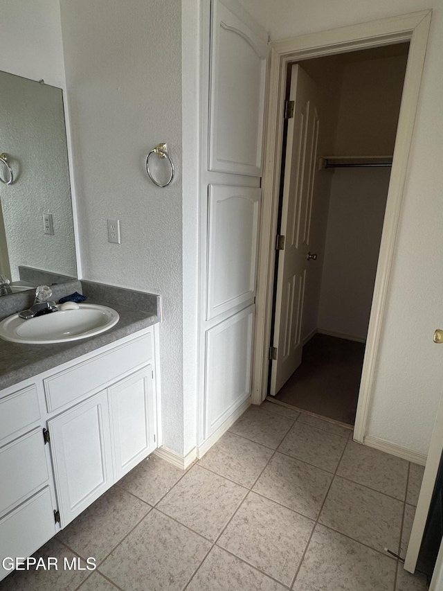 bathroom with tile patterned flooring and vanity