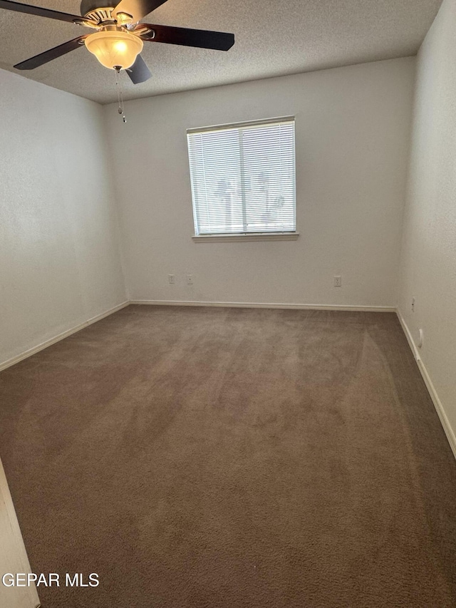 spare room with carpet, ceiling fan, and a textured ceiling