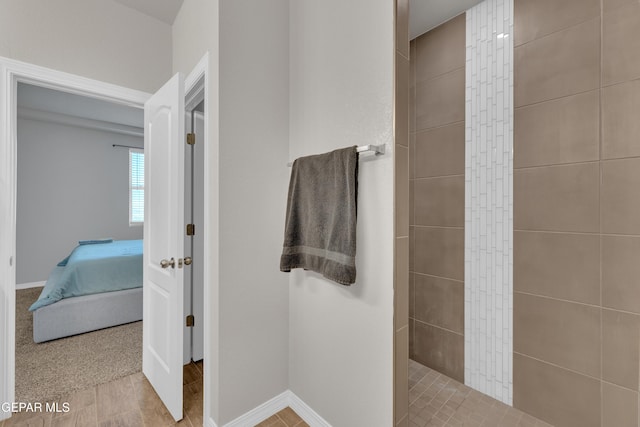 bathroom featuring baseboards, a walk in shower, and connected bathroom