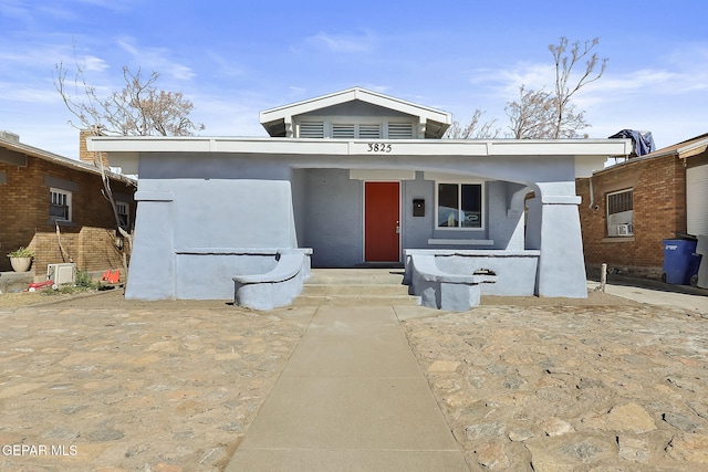 view of front of property featuring a porch and stucco siding