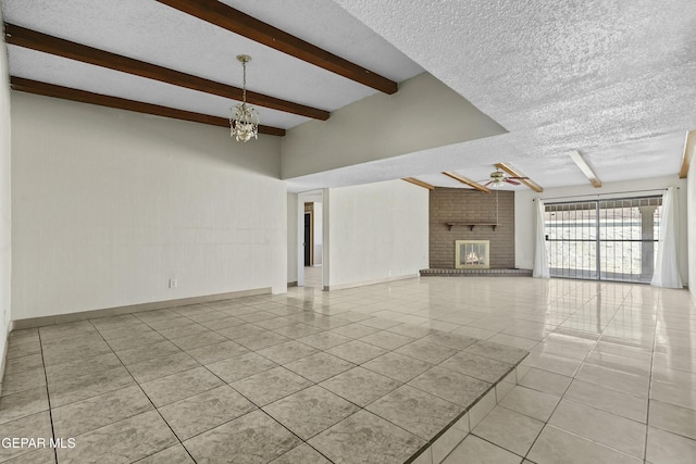 unfurnished living room featuring ceiling fan with notable chandelier, light tile patterned floors, a brick fireplace, and a textured ceiling