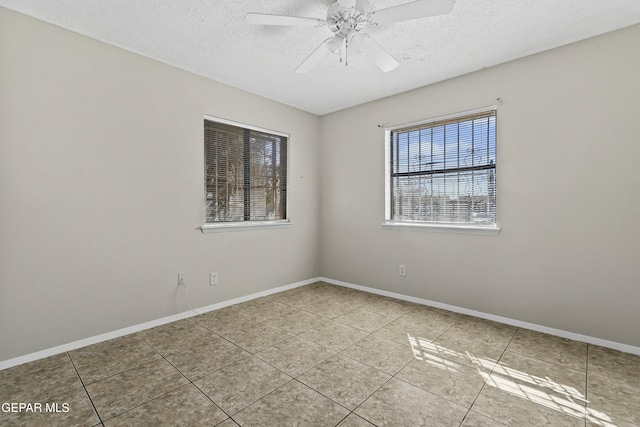 tiled empty room featuring ceiling fan and a textured ceiling