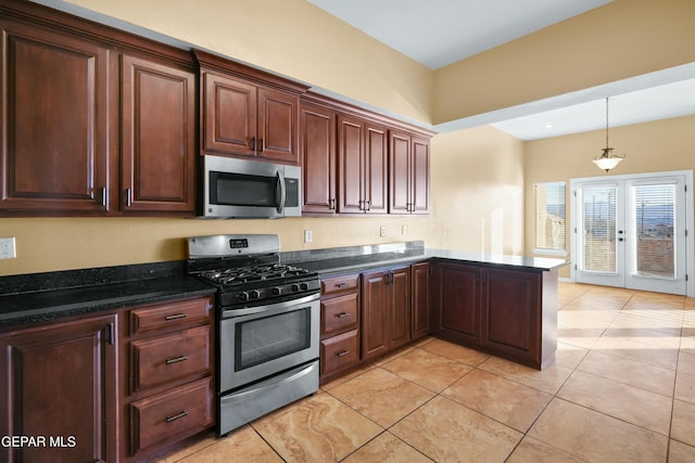 kitchen featuring dark stone countertops, a peninsula, stainless steel appliances, french doors, and pendant lighting