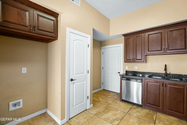 kitchen with a sink, baseboards, stainless steel dishwasher, and light tile patterned flooring